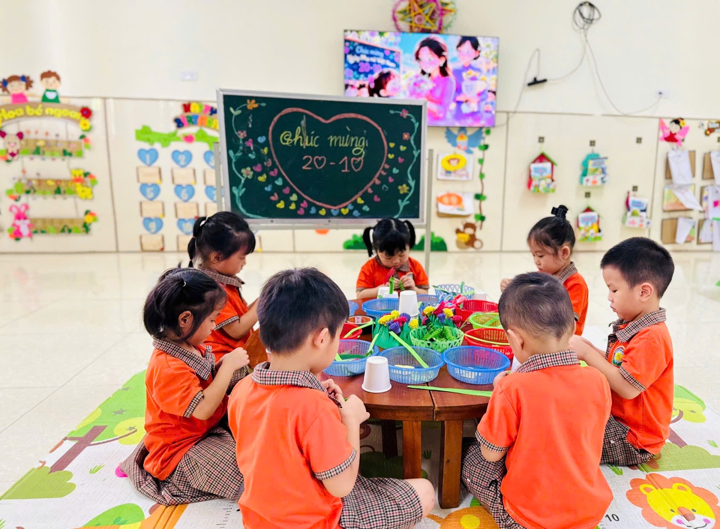 'A group of children sitting around a table
Description automatically generated'