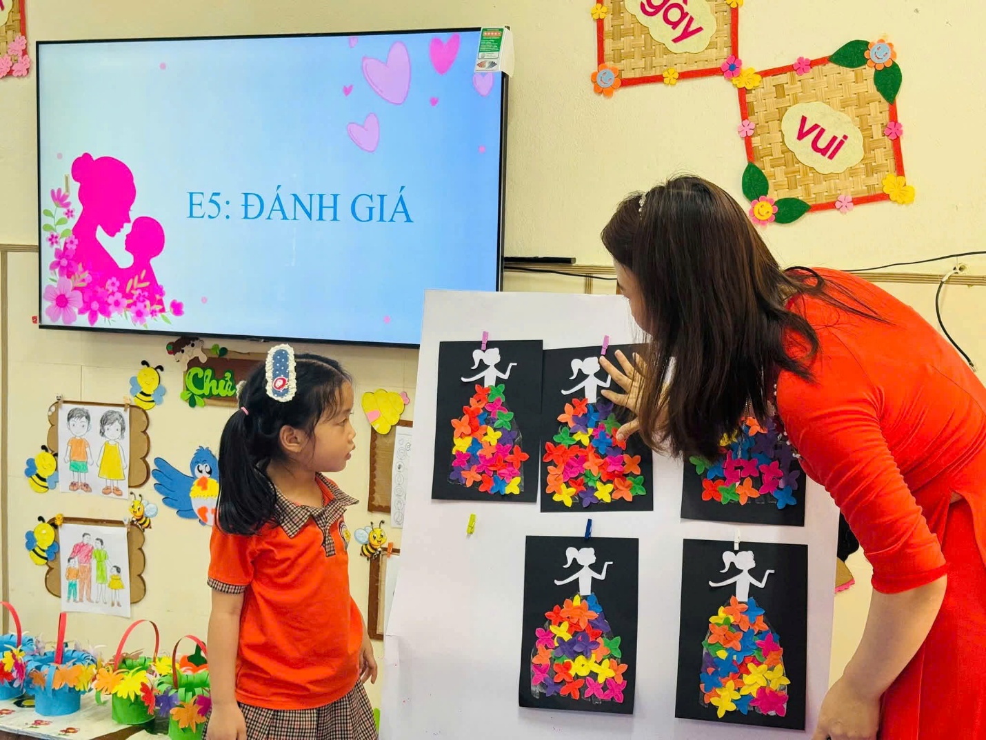 'A person and a child looking at a piece of paper
Description automatically generated'
