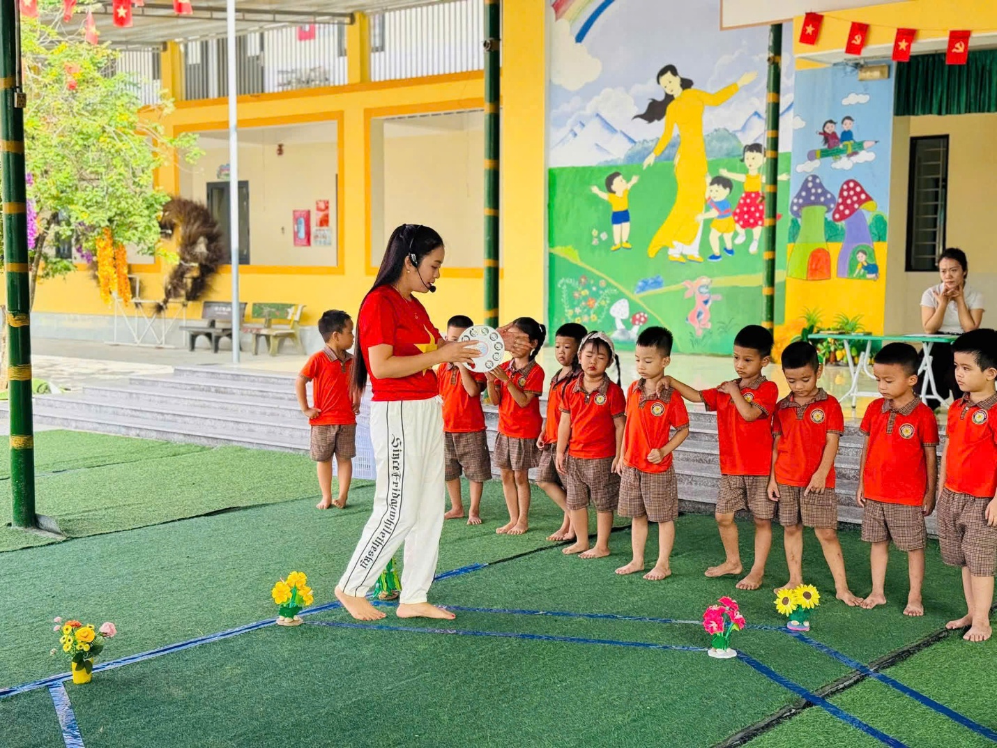 'A group of children standing in a line
Description automatically generated'